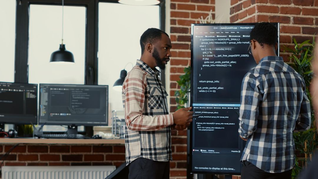 Two People Are Talking About the Code on the Display | TechReviewGarden